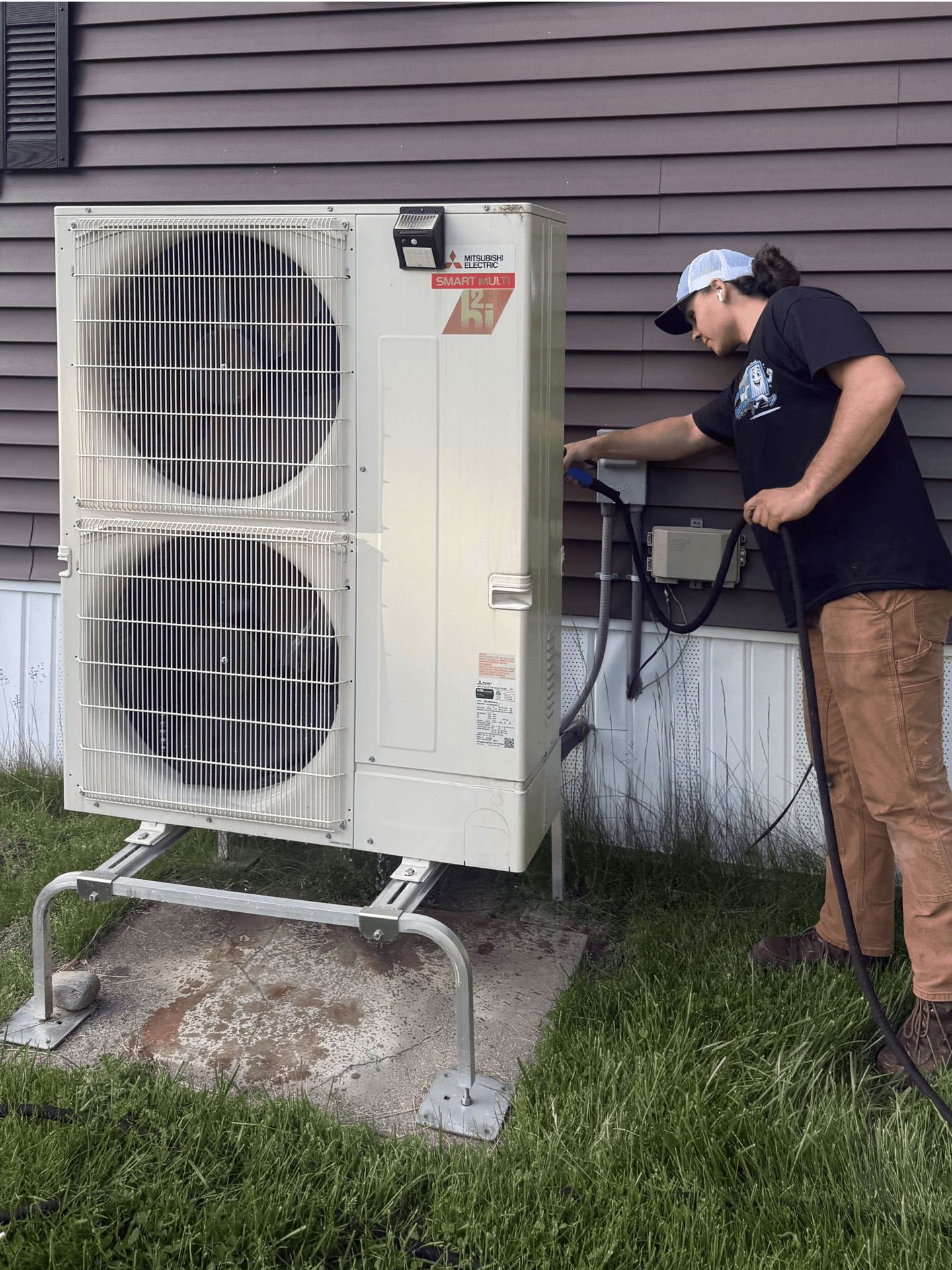 Coil cleaning in progress on a residential outdoor unit